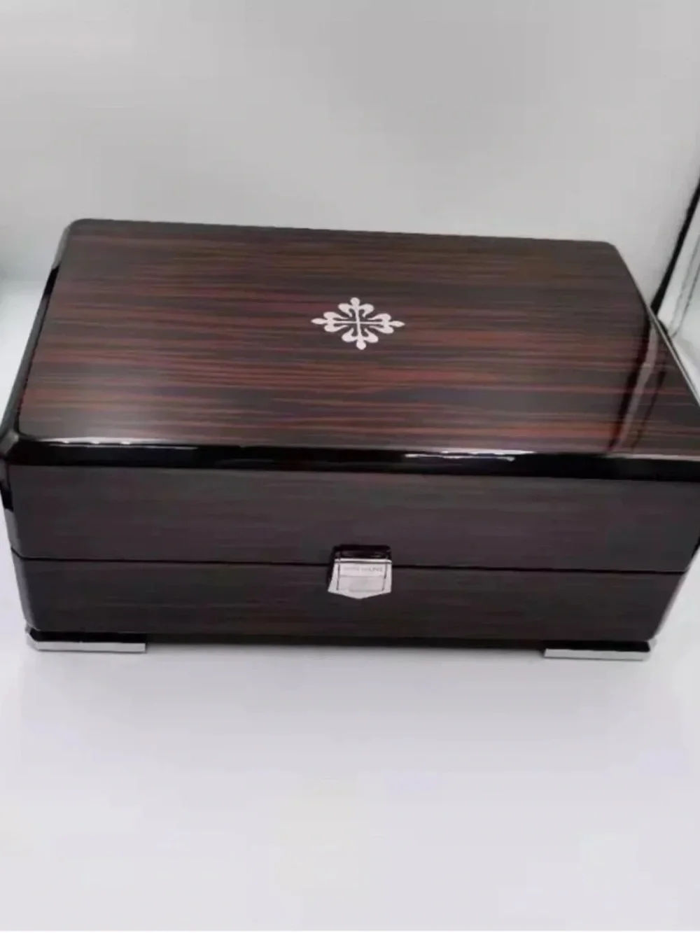 Patek Philippe Brown and Black High-Gloss Wood Watch Box with Silver Emblem